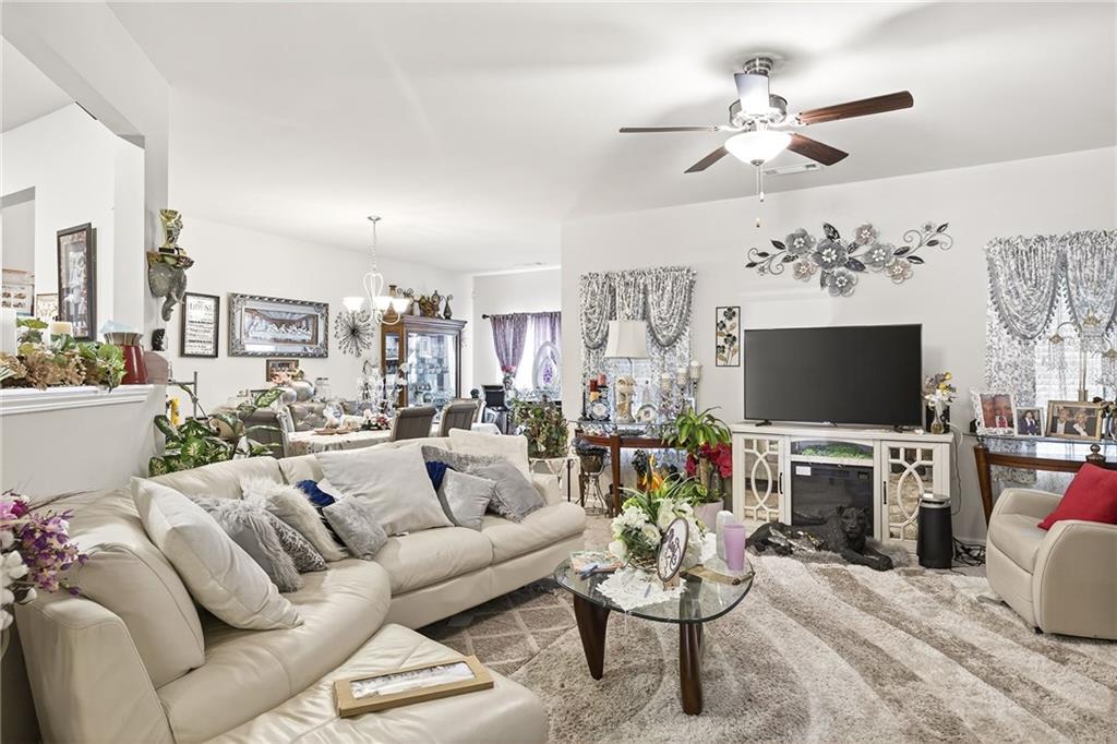 89 Dundee Crossing Dallas, GA 30132 - Photo 7 of 30 a living room with fireplace furniture and a flat screen tv
