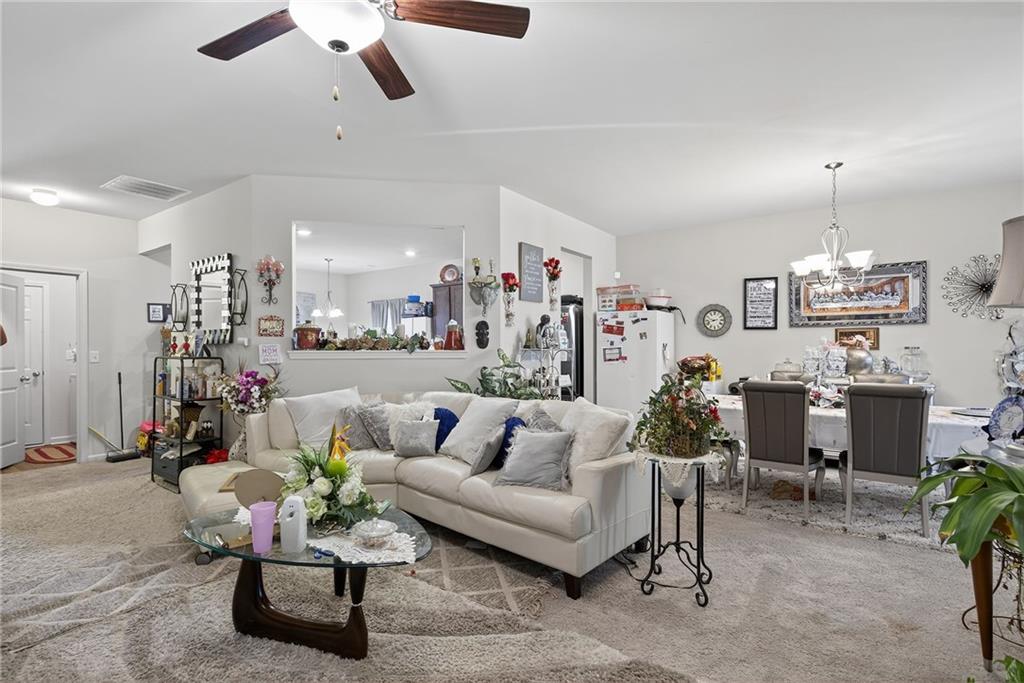 89 Dundee Crossing Dallas, GA 30132 - Photo 9 of 30 a living room with furniture and a chandelier
