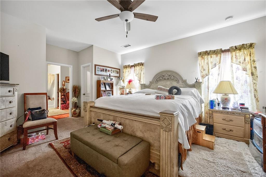 89 Dundee Crossing Dallas, GA 30132 - Photo 10 of 30 a bedroom with a bed and wooden floor