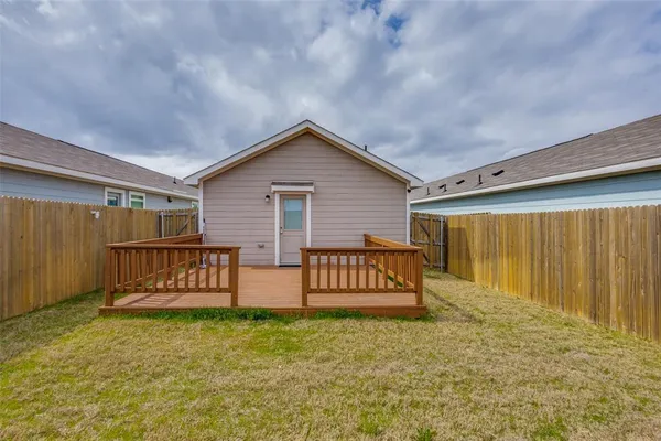 a view of a house with wooden fence