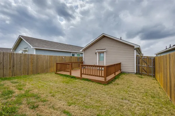 a view of a house with wooden fence