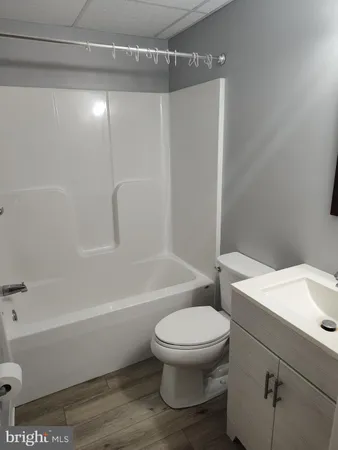 a bathroom with a toilet and a tub