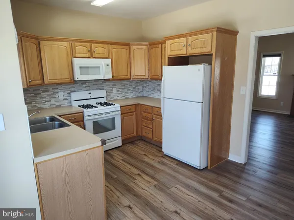 a kitchen with a refrigerator sink and stove