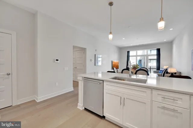 a bathroom with a granite countertop toilet a sink and a mirror