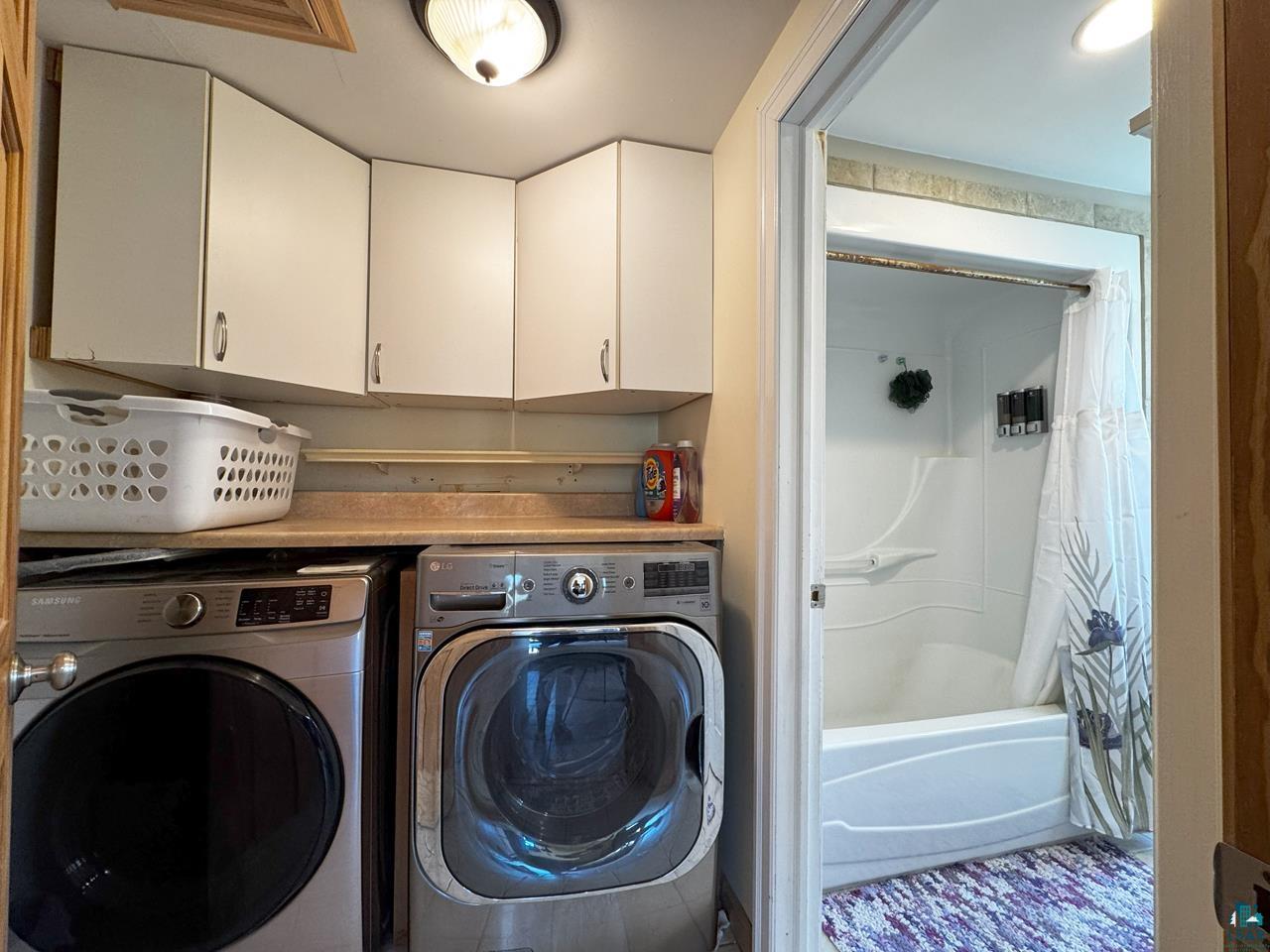 10362 Arkola Road Meadowlands, MN 55765 - Photo 11 of 30 Washroom featuring washing machine and clothes dryer and cabinet space
