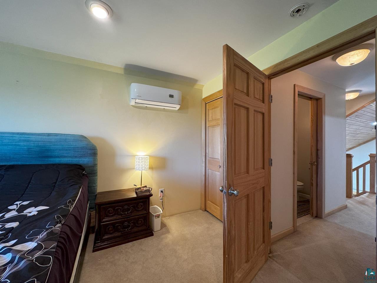 10362 Arkola Road Meadowlands, MN 55765 - Photo 17 of 30 Carpeted bedroom with a wall mounted AC