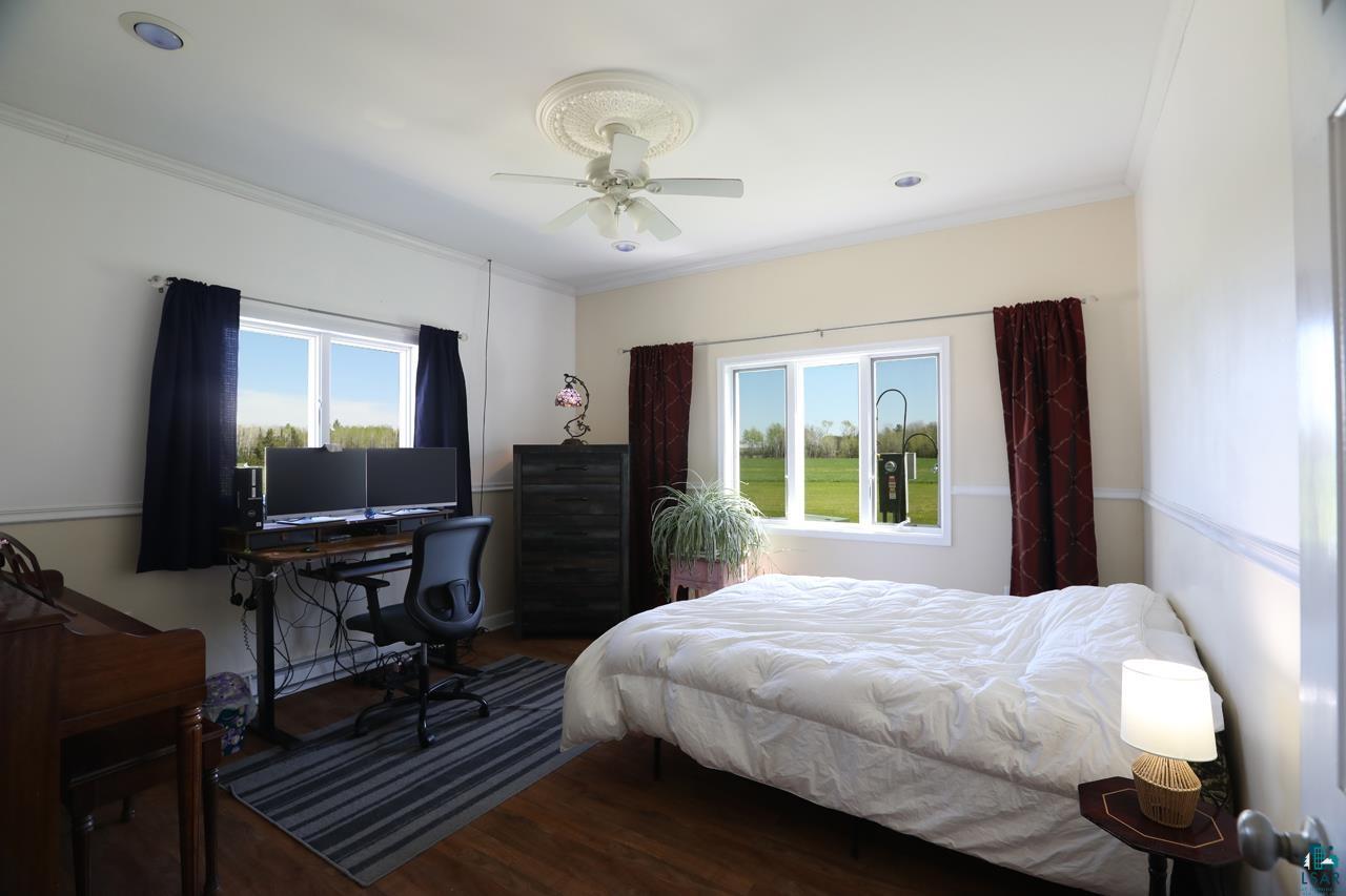 10362 Arkola Road Meadowlands, MN 55765 - Photo 8 of 30 Bedroom with crown molding, wood finished floors, and a ceiling fan