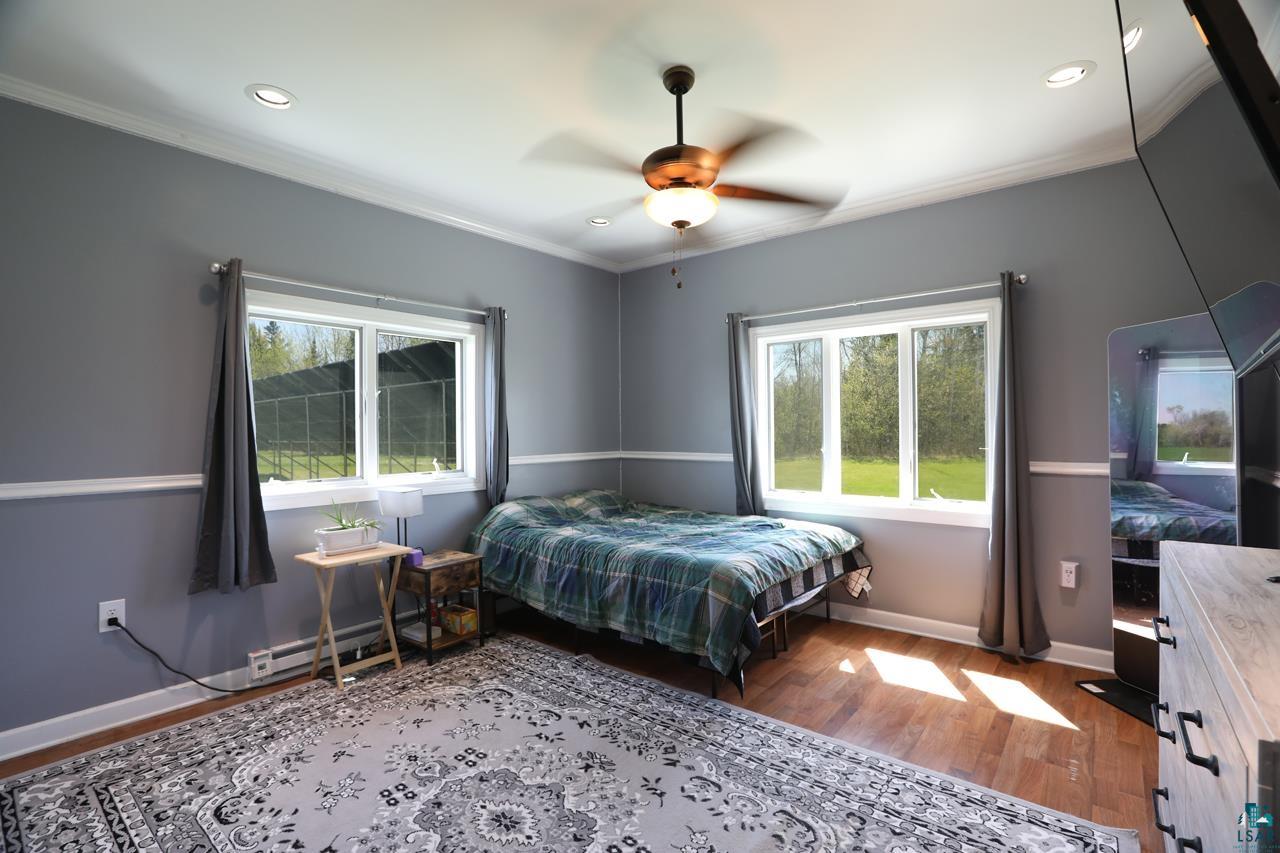 10362 Arkola Road Meadowlands, MN 55765 - Photo 9 of 30 Bedroom with crown molding, wood finished floors, baseboards, recessed lighting, and a ceiling fan