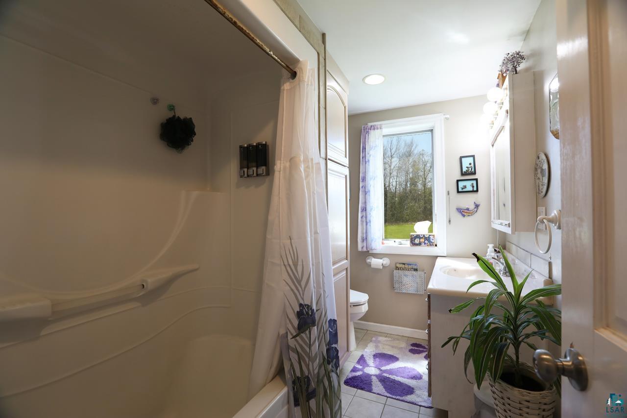 10362 Arkola Road Meadowlands, MN 55765 - Photo 10 of 30 Bathroom with toilet, tile patterned flooring, vanity, baseboards, and recessed lighting