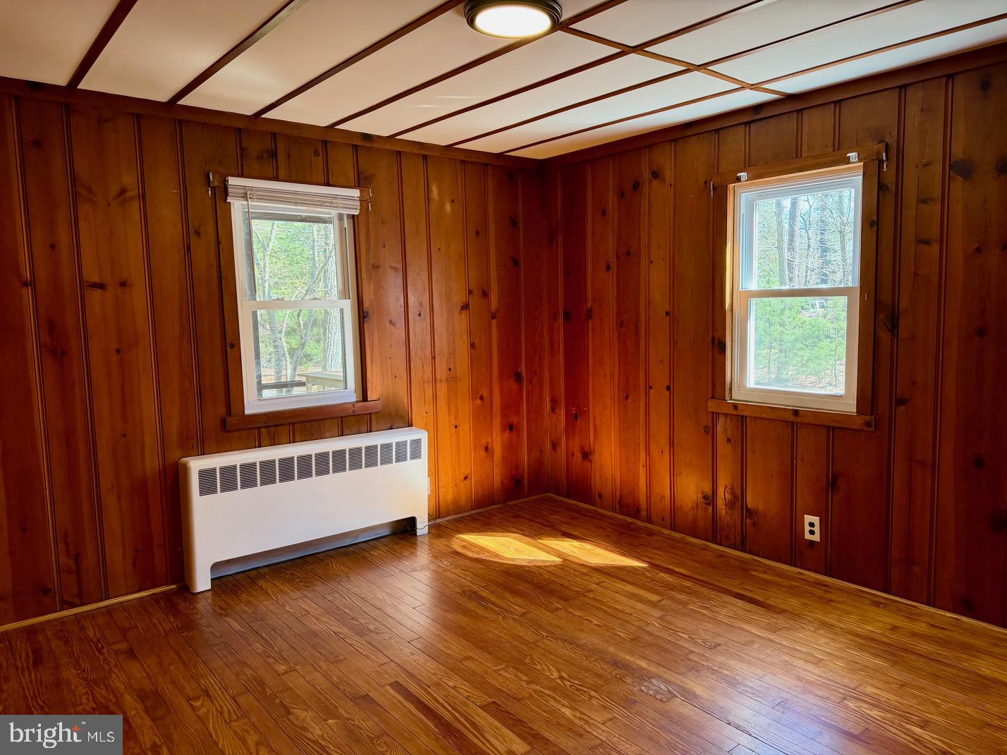 1176 Stokes Road Medford, NJ 08055 - Photo 10 of 27 an empty room with wooden floor and windows
