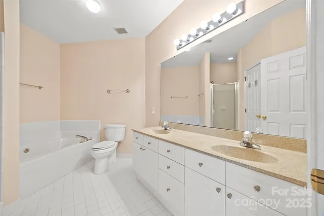 a spacious bathroom with a granite countertop sink a toilet and shower