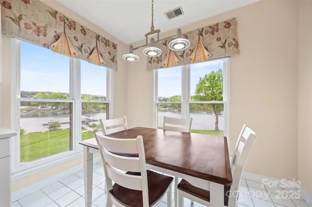 a view of a dining room with furniture large windows and wooden floor