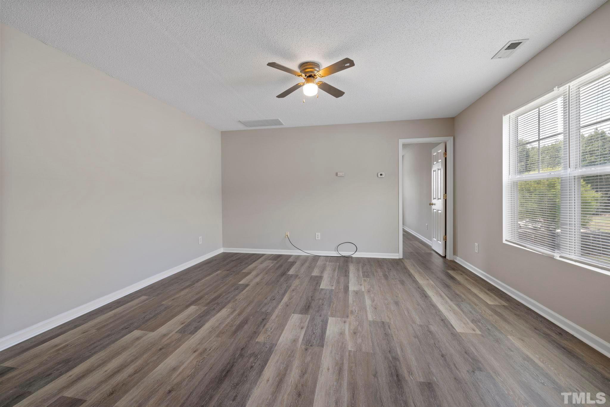 3519 Mountain Brook Circle Durham, NC 27704 - Photo 13 of 24 wooden floor in an empty room with a window