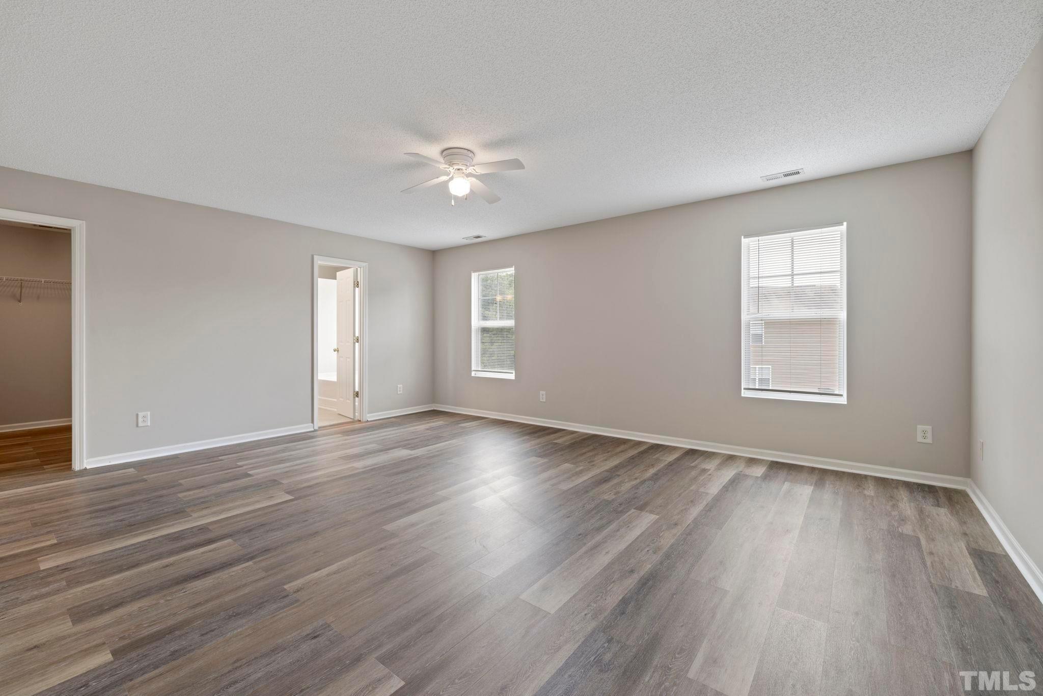 3519 Mountain Brook Circle Durham, NC 27704 - Photo 14 of 24 a view of an empty room with wooden floor and a window