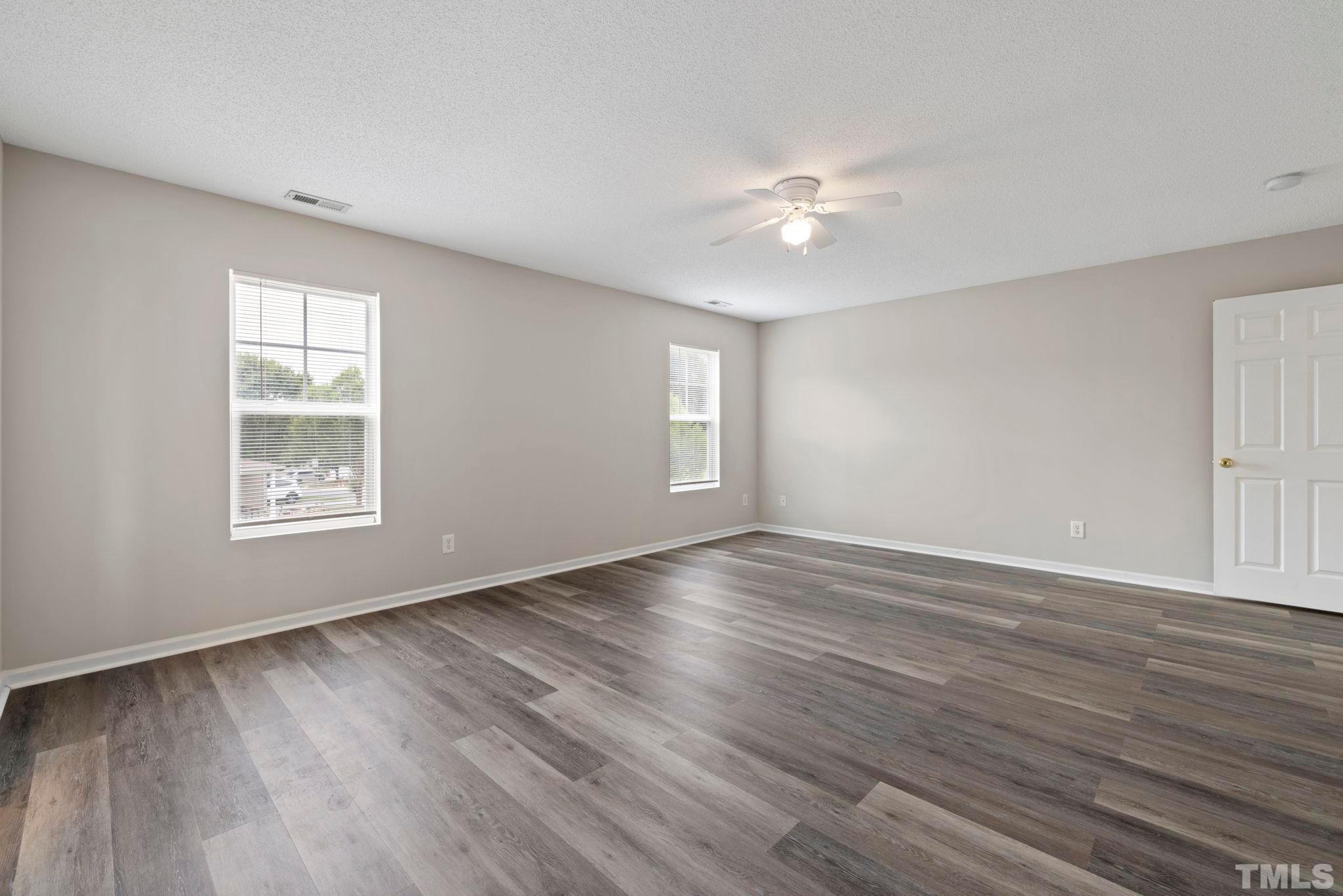 3519 Mountain Brook Circle Durham, NC 27704 - Photo 16 of 24 a view of an empty room with window and wooden floor