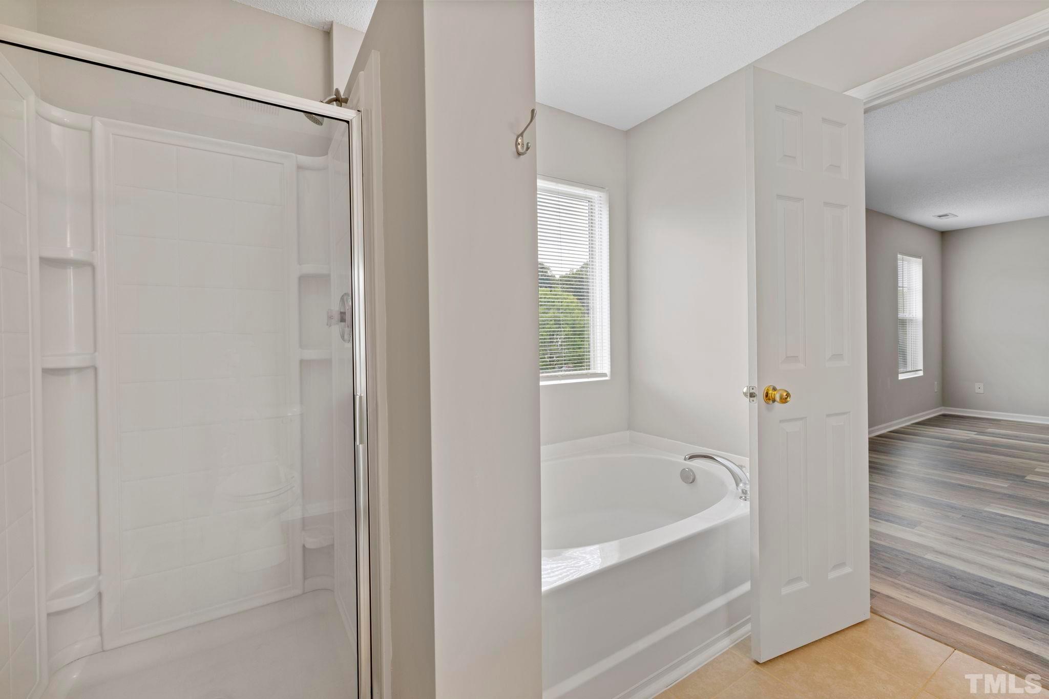 3519 Mountain Brook Circle Durham, NC 27704 - Photo 19 of 24 a white bath tub sitting next to a shower