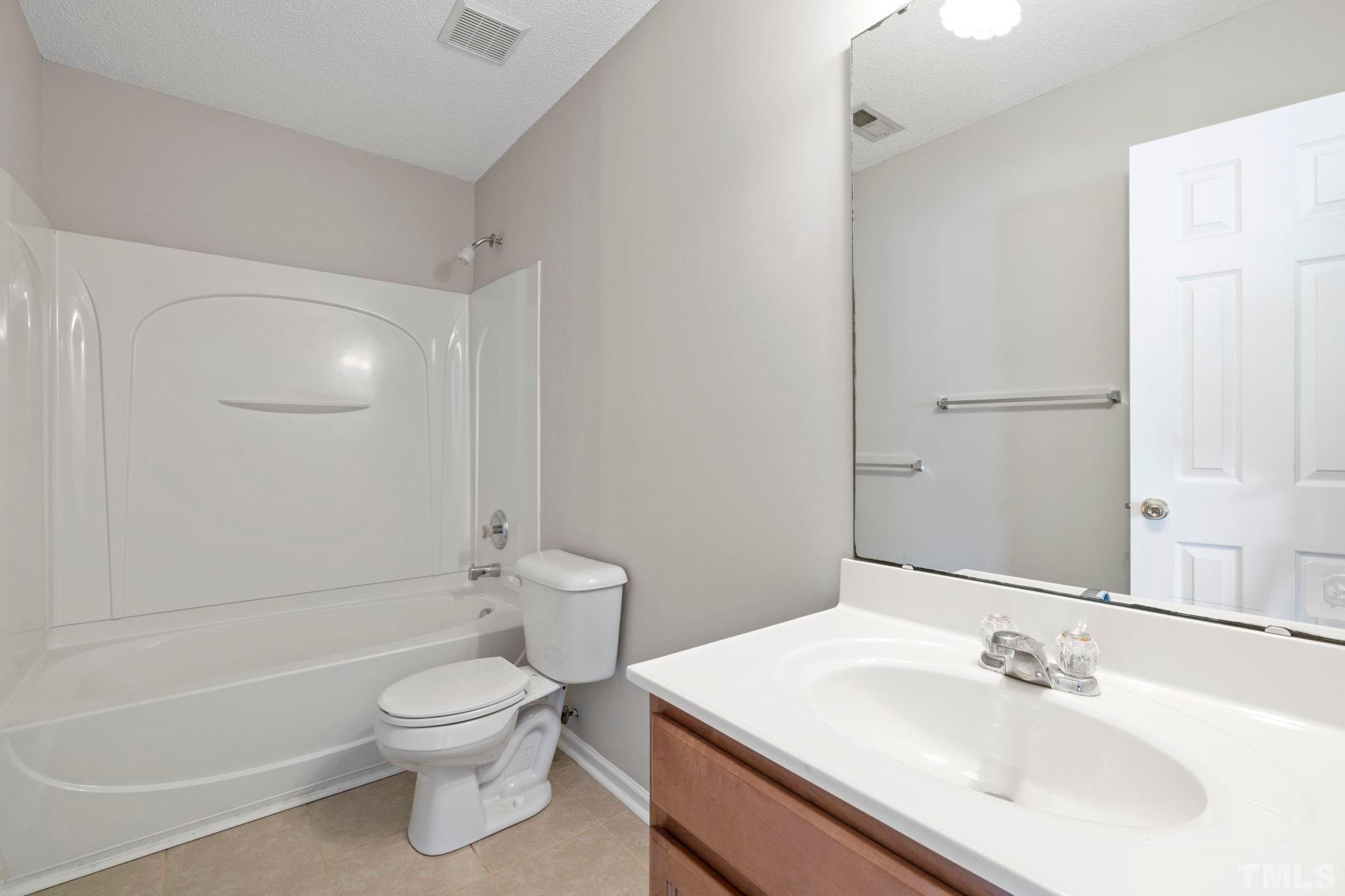 3519 Mountain Brook Circle Durham, NC 27704 - Photo 22 of 24 a bathroom with a sink toilet and shower