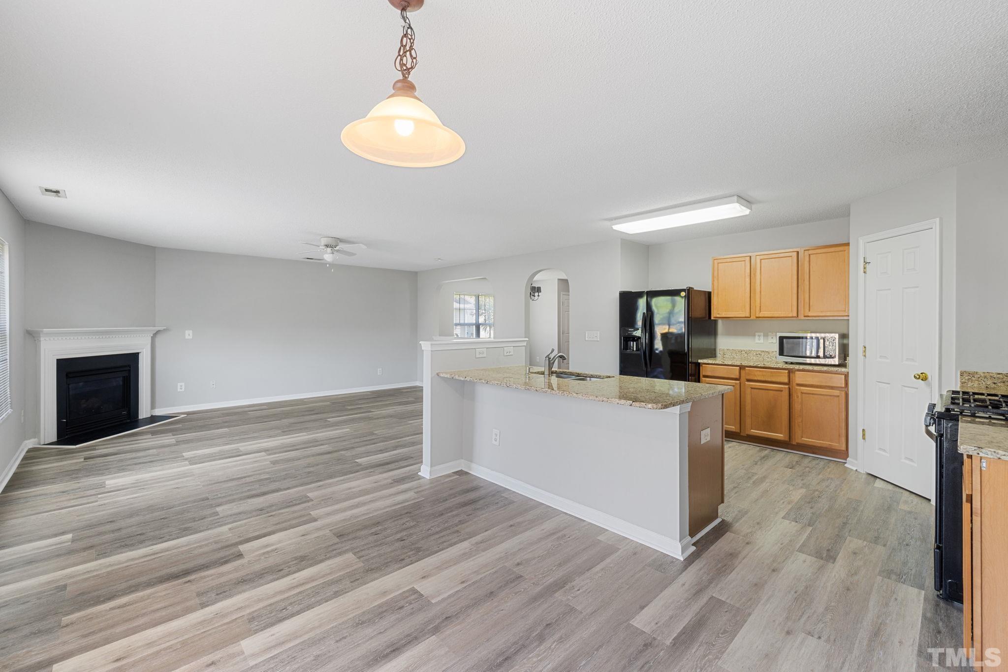 3519 Mountain Brook Circle Durham, NC 27704 - Photo 5 of 24 a kitchen with a refrigerator and a stove top oven