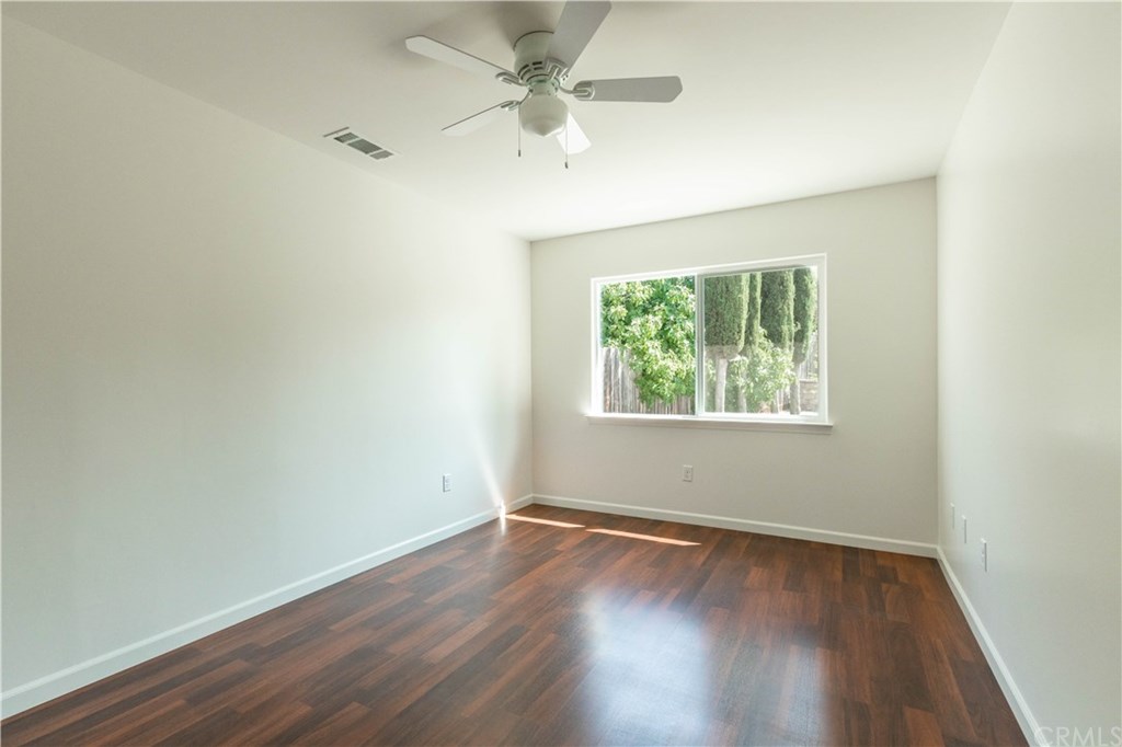 914 Brookhill Drive Paso Robles, CA 93446 - Photo 13 of 20 an empty room with wooden floor and windows