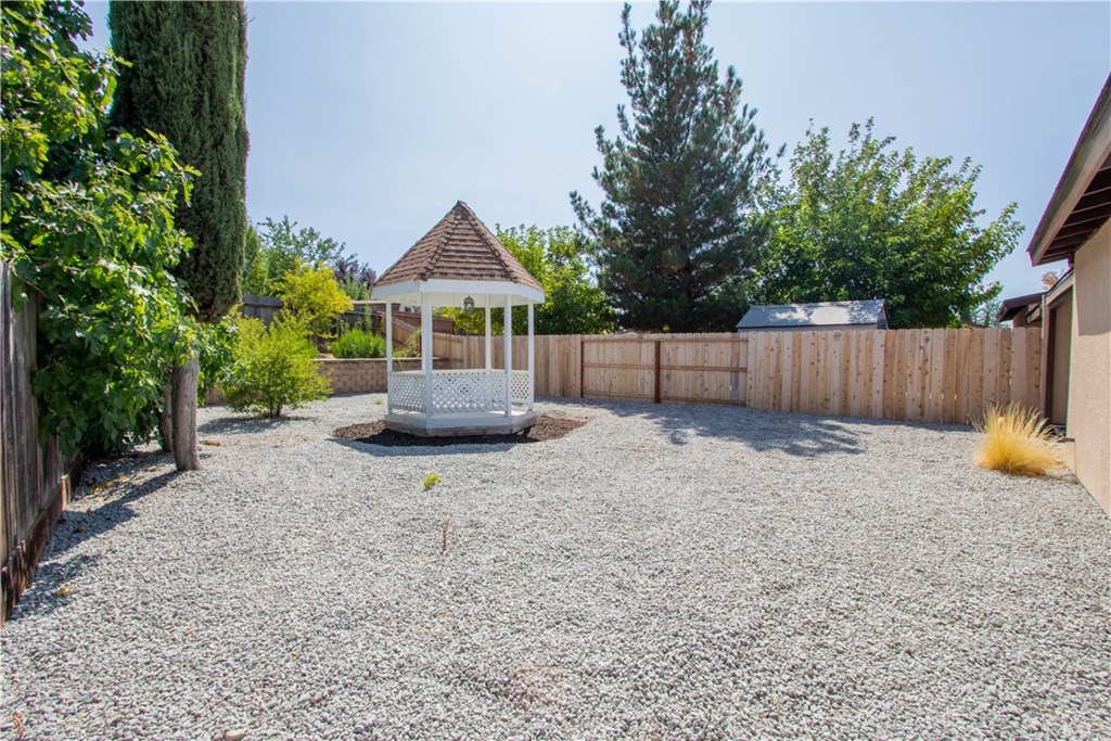 914 Brookhill Drive Paso Robles, CA 93446 - Photo 17 of 20 a view of a backyard with a garden and tree