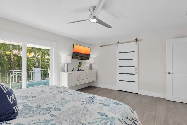 a bedroom with furniture and flat screen tv