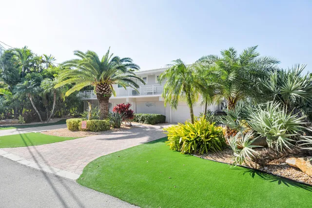 a view of a house with swimming pool and sitting area