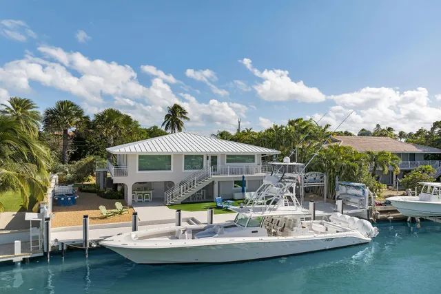 a view of a patio with table and chairs and potted plants