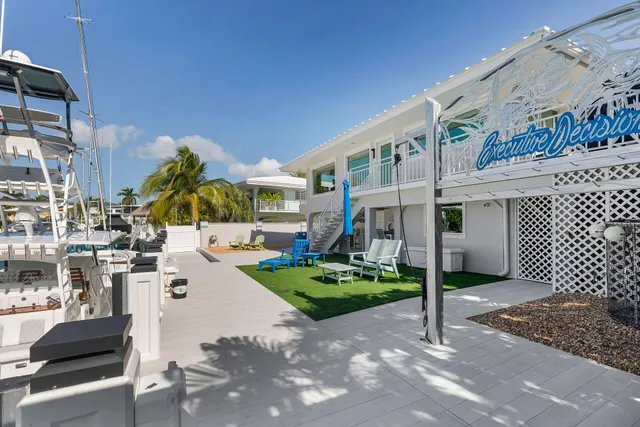 a view of a house with backyard water and sitting area
