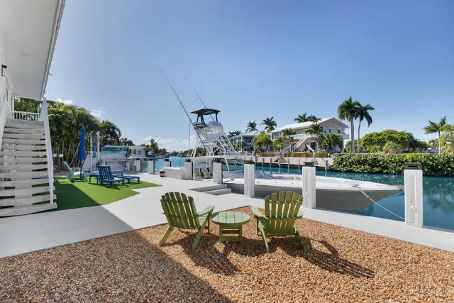 a swimming pool with outdoor seating and yard