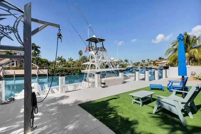 a view of a chair and table in the back yard of the house