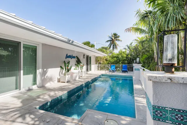 a view of a swimming pool with outdoor seating