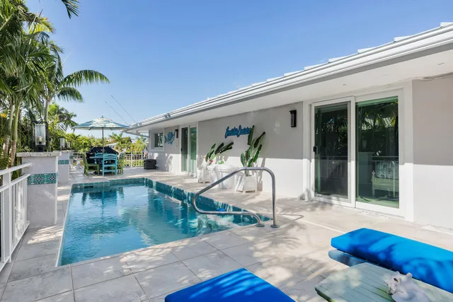 a view of a dining room with furniture a chandelier and wooden floor