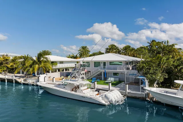 a small pool with couple of chairs