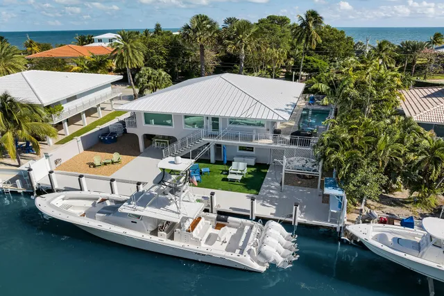 a large white kitchen with a large window