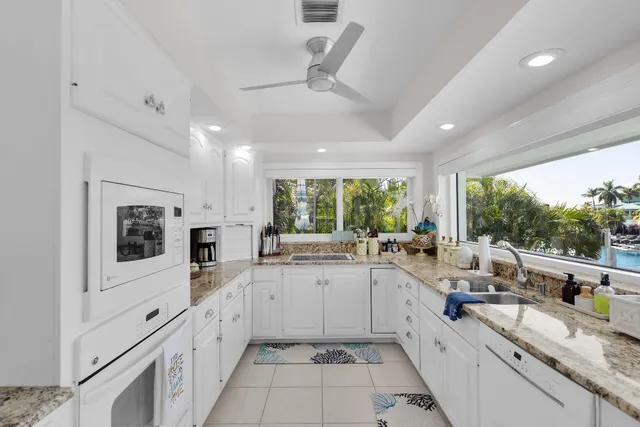 an aerial view of ocean and residential houses with outdoor space