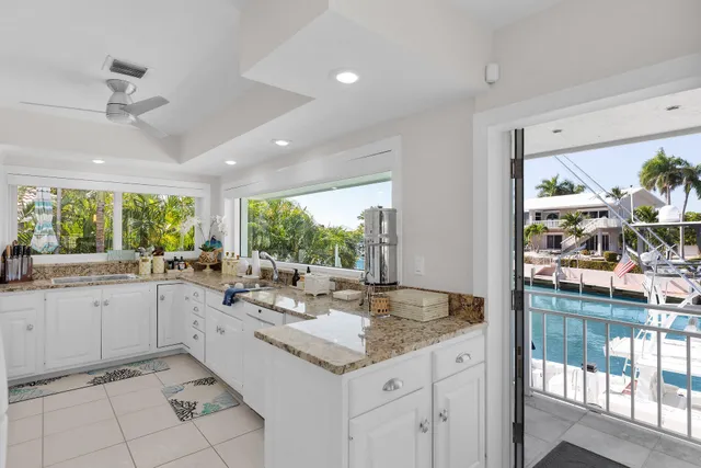 a kitchen with sink and view living room