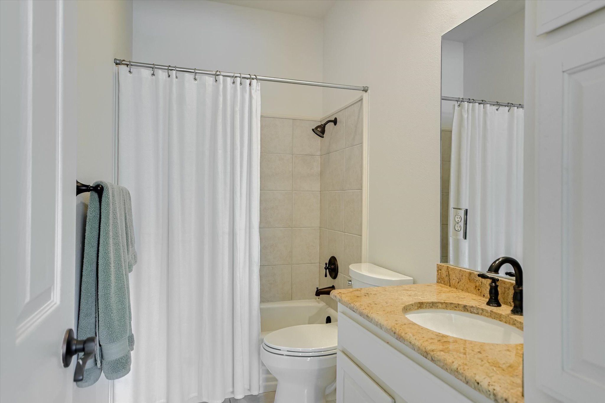 2901 Maravillas Loop Austin, TX 78735 - Photo 22 of 31 a bathroom with a granite countertop sink a toilet and a mirror