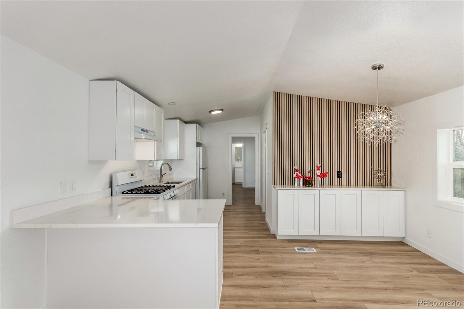 8466 Adams Way Denver, CO 80229 - Photo 13 of 31 a living room with furniture and a table