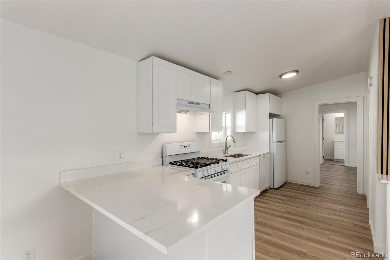 8466 Adams Way Denver, CO 80229 - Photo 15 of 31 a kitchen with a sink stainless steel appliances and cabinets