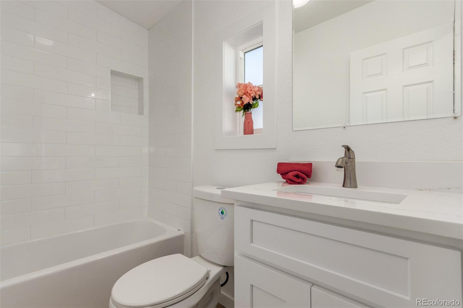 8466 Adams Way Denver, CO 80229 - Photo 28 of 31 a bathroom with a sink toilet and shower
