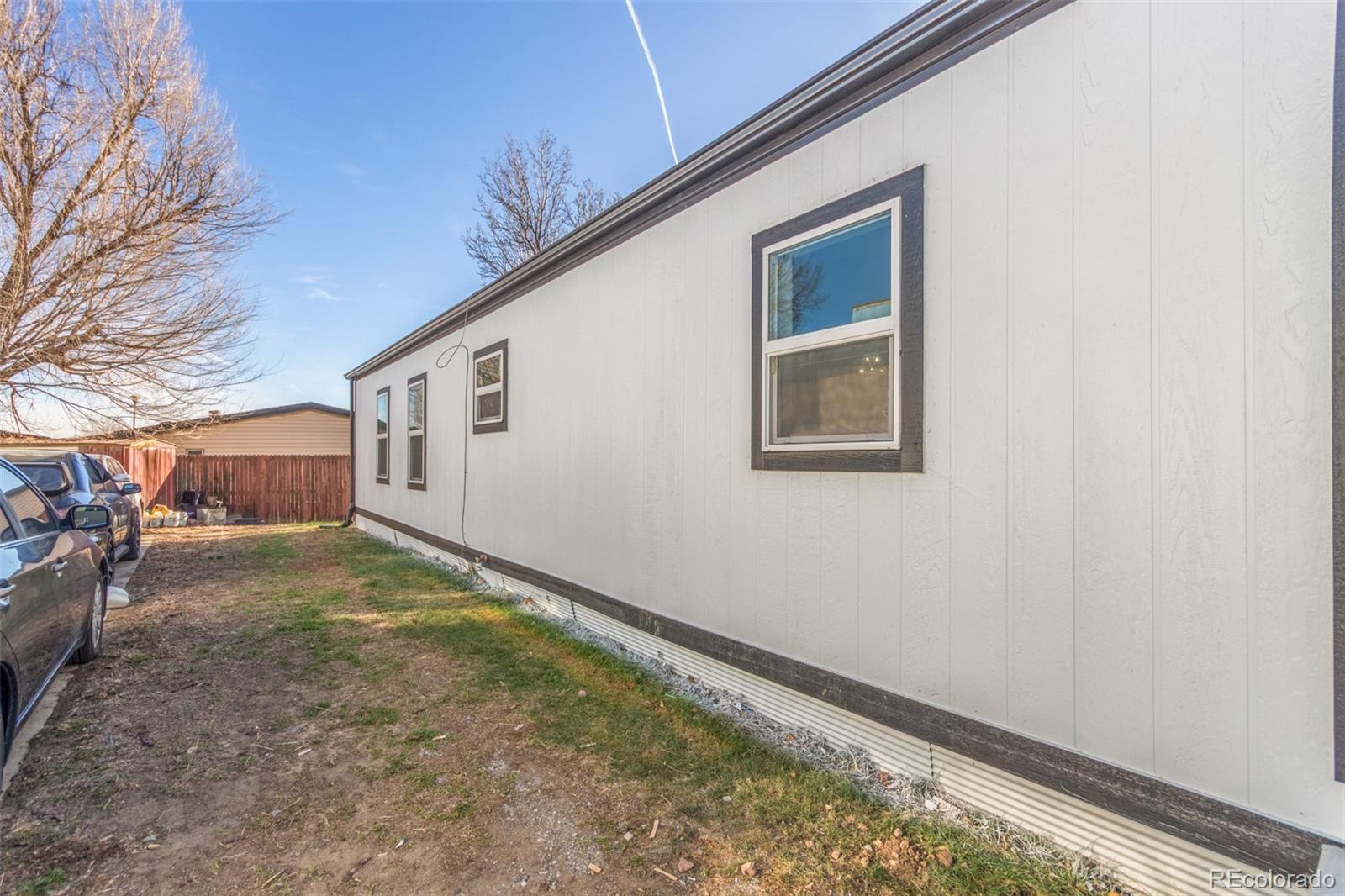 8466 Adams Way Denver, CO 80229 - Photo 30 of 31 a view of a house with a yard