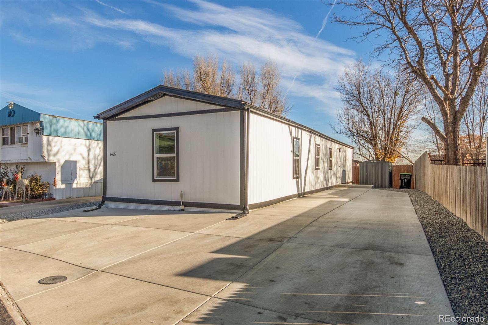8466 Adams Way Denver, CO 80229 - Photo 4 of 31 a view of a house with a yard