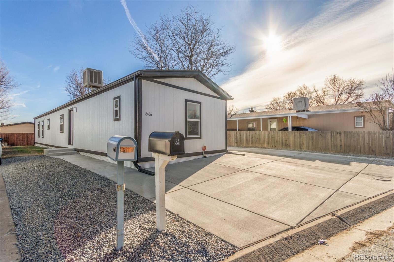 8466 Adams Way Denver, CO 80229 - Photo 5 of 31 a front view of a house with garden