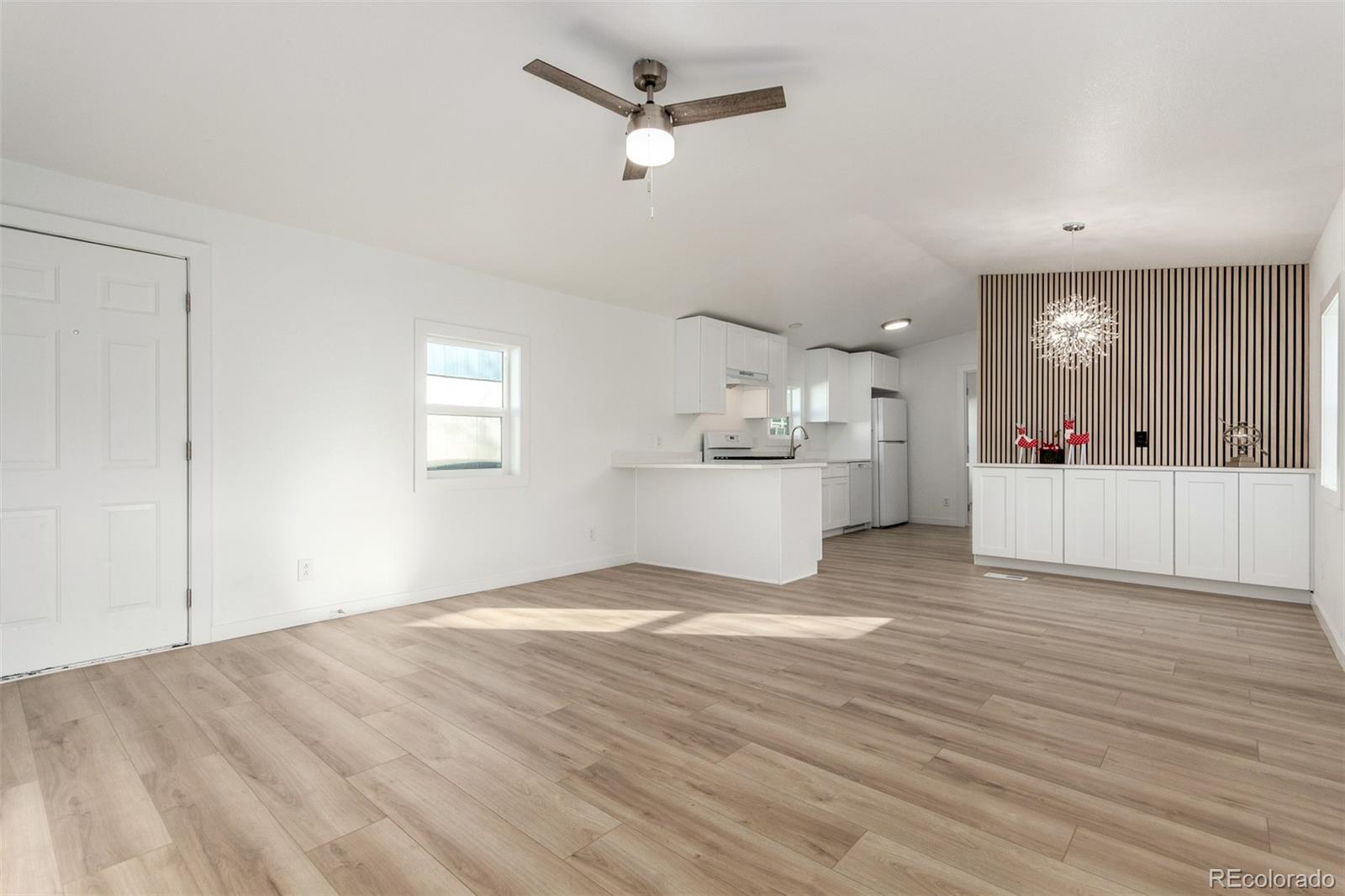 8466 Adams Way Denver, CO 80229 - Photo 6 of 31 a view of a kitchen with a microwave and cabinets