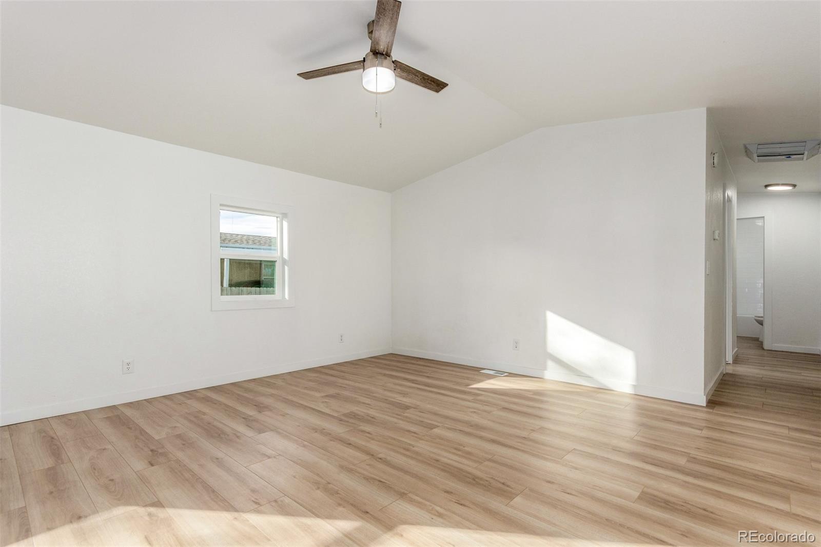 8466 Adams Way Denver, CO 80229 - Photo 8 of 31 a view of empty room with wooden floor
