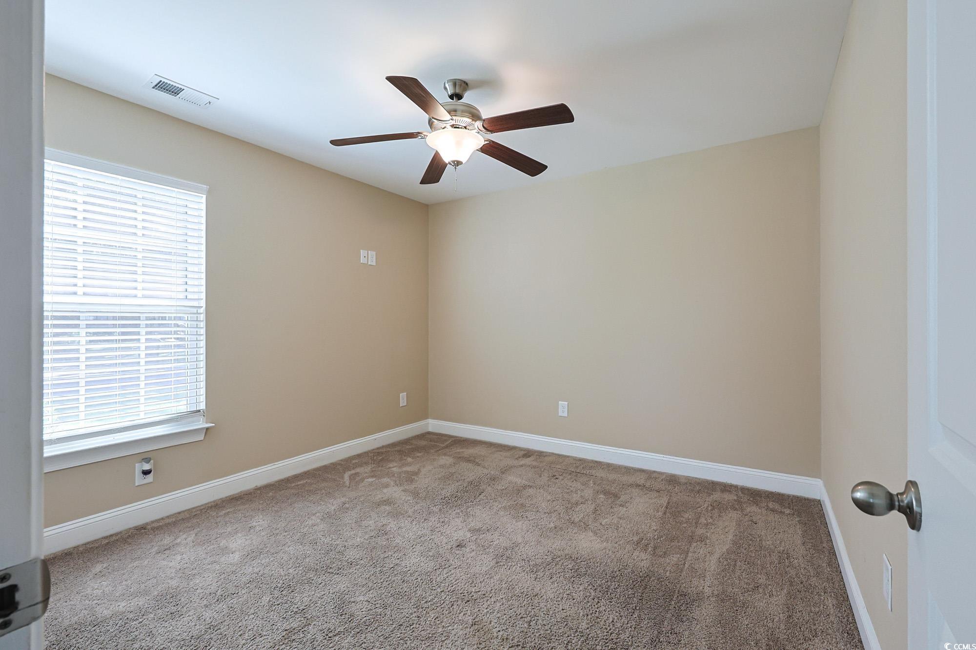 13 Daniel Morrall Lane Georgetown, SC 29440 - Photo 19 of 30 Empty room with light carpet and ceiling fan
