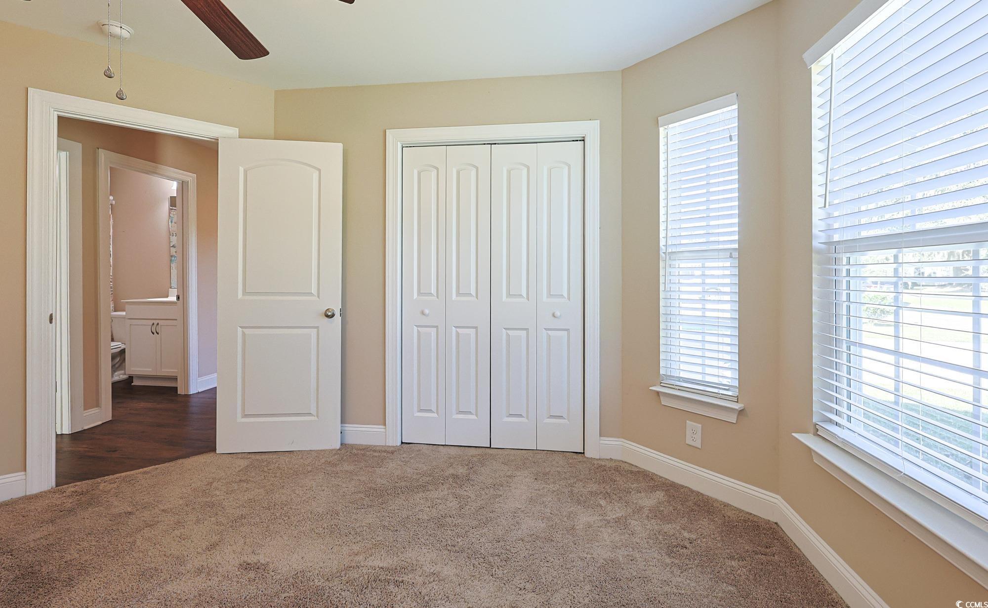 13 Daniel Morrall Lane Georgetown, SC 29440 - Photo 21 of 30 Unfurnished bedroom with dark colored carpet, a closet, and ceiling fan