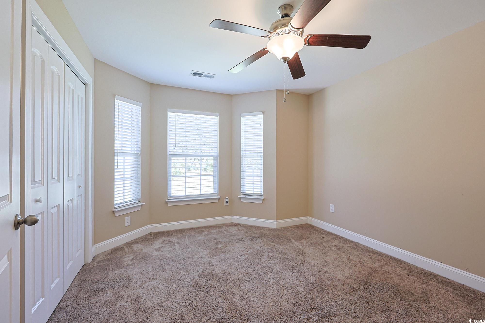 13 Daniel Morrall Lane Georgetown, SC 29440 - Photo 22 of 30 Unfurnished bedroom featuring carpet floors, a closet, and ceiling fan
