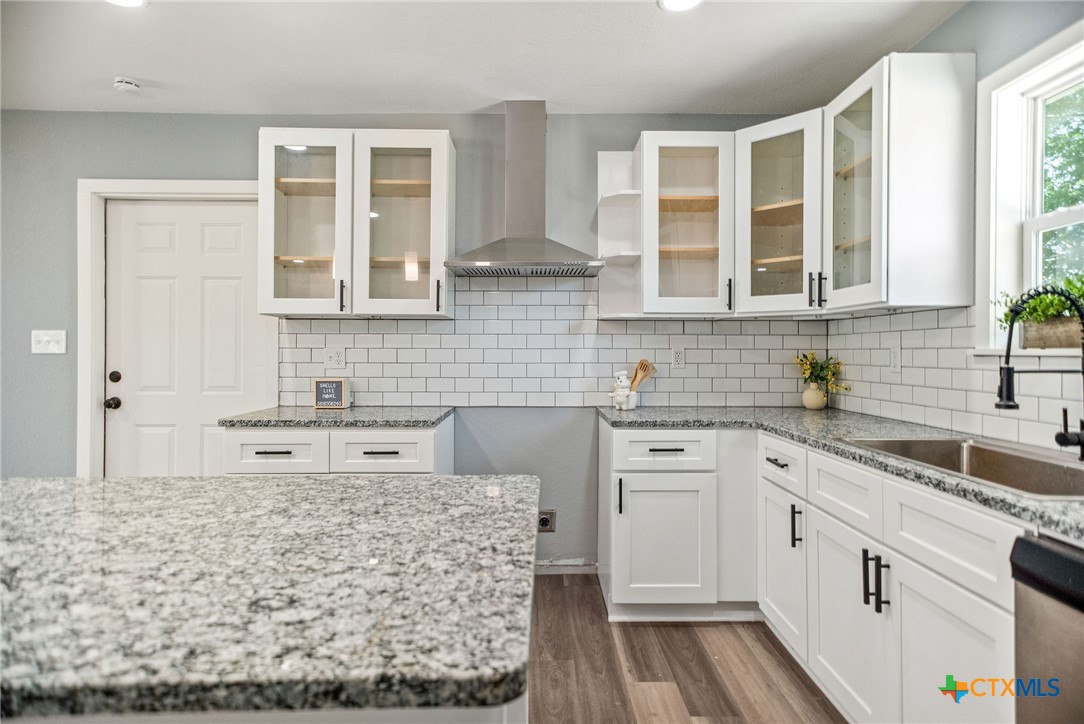 210 Travis Street Port Lavaca, TX 77979 - Photo 5 of 28 Custom kitchen cabinets, quartz countertops, and an island!