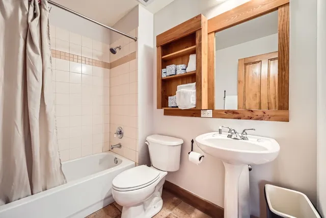 a bathroom with a sink toilet and shower